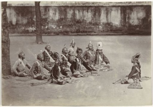 Javanese men sitting on the ground in a kraton