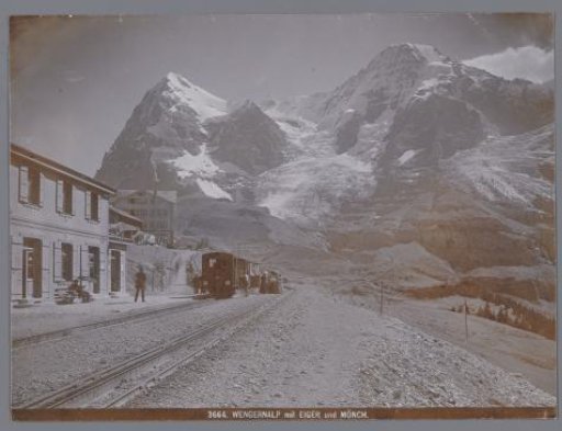 View of a railway in Wengen at the foot of the Eiger and the Mönch in the Bernese Alps, with hotel Jungfrau on the left