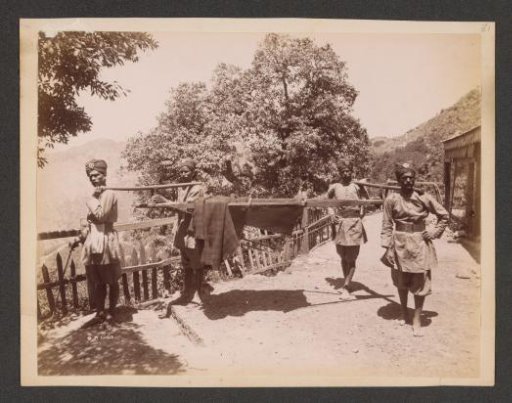 Four Indian men in unform life a palanquin, India