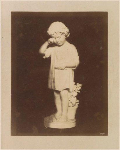 Sculpture of a crying child before a trough with flowers