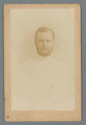 Portrait of a bearded man in a white suit