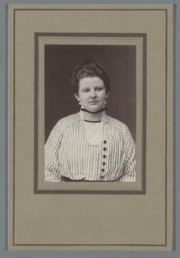 Portrait of a young woman in a dress with a striped pattern
