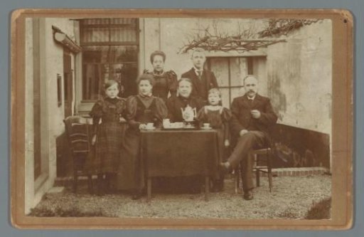 Family portrait at a table in a courtyard