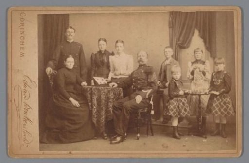Group portrait of a family with an open photo album on a table