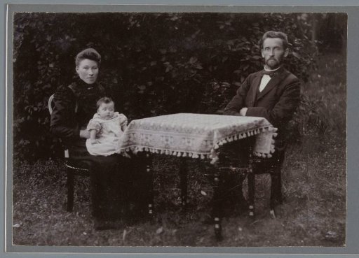 Portrait of an Unknown Man and Woman with a Baby at a Table Outdoors