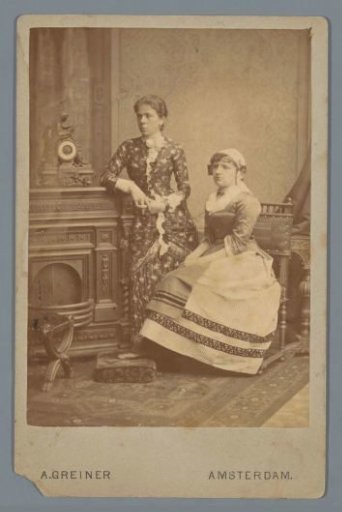 Portrait of two unknown women, one of whom is wearing traditional dress