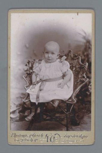 Studio portrait of a child on a wicker chair
