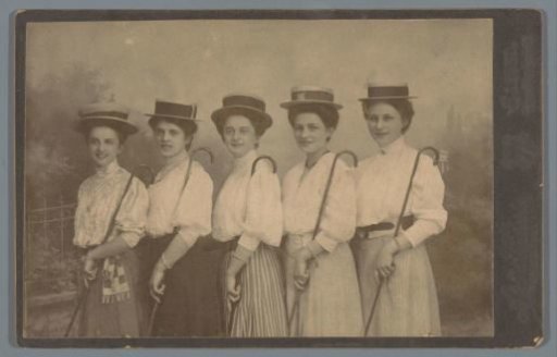 Group portrait of five unknown women with hats and walking sticks