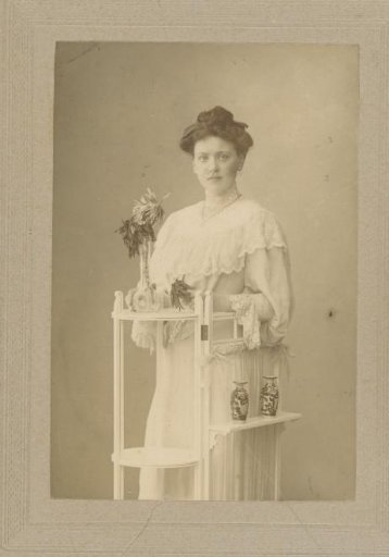 Portrait of an unknown woman at a pedestal with vases