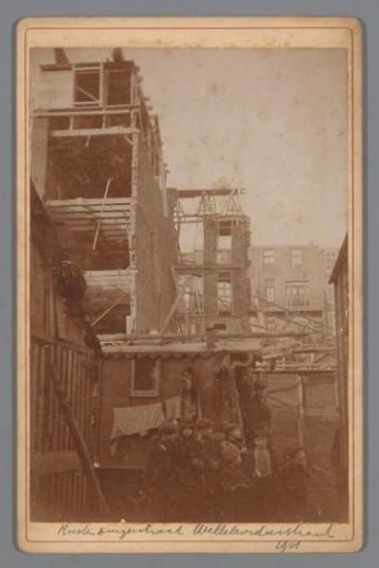 Group of children in front of a collapsed building on the Sint Willibrordusstraat or on the Rustenburgerstraat in Amsterdam