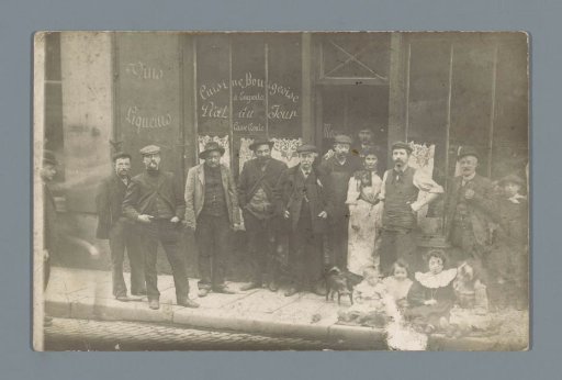 Group of people posing in front of a restaurant