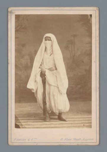 Algerian woman in harem trousers and veil