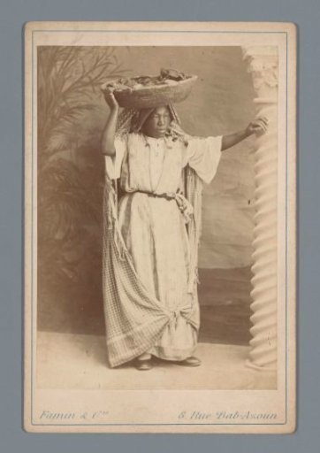 Algerian woman with a basket on her head