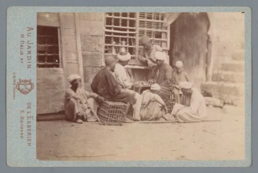 Group of people outside at a café with a board game