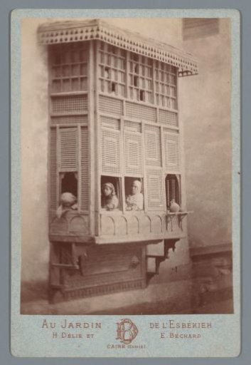 Woman and children at windows of an extension