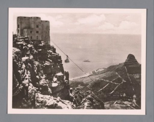 View of a cable car station on Table Mountain and in the distance Lion's Head in Cape Town