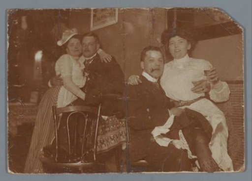 Two Men with Women on Their Knees in a Café