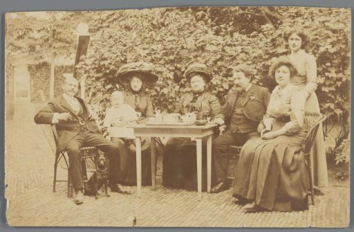 Portrait of a group of unknown men and women, a baby and a dog