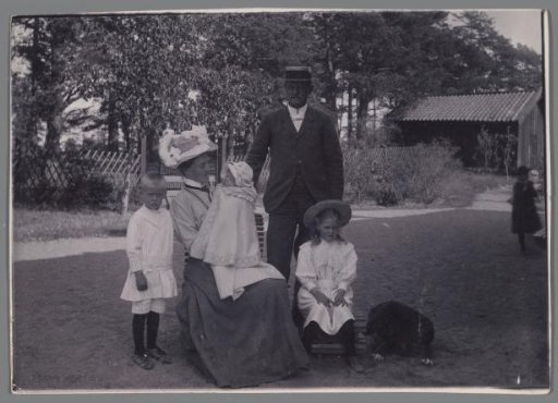 Family Portrait of an Unknown Married Couple, Three Children, and a Dog in a Garden