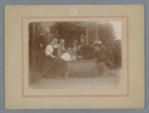Group Portrait of Wilhelmina Gerarda Hoogendijk with (presumably) Family Members Around a Wicker Basket in a Garden
