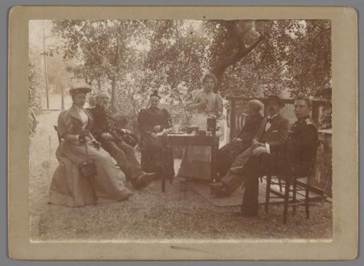 Group Portrait of Four Unknown Women and Three Men Around a Table in a Garden