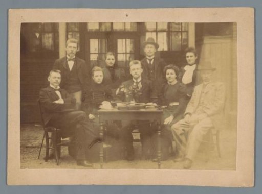Group Portrait of an Unknown Family Around a Table with a Violin