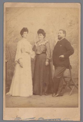 Group portrait of two unknown women and a man