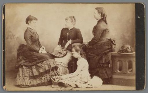 Three seated women in bustles and a girl with a flower basket