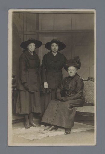 Portrait of two unknown women and a seated elderly woman