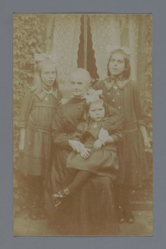 Studio portrait of (presumably) a grandmother with three granddaughters
