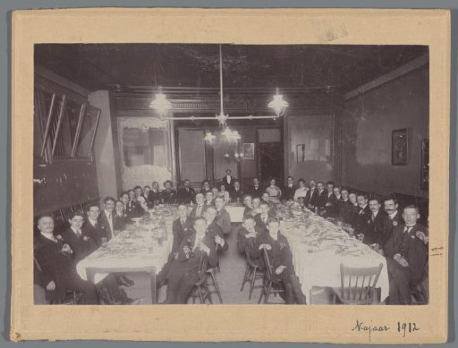 Group portrait of unknown Dutch students at a table