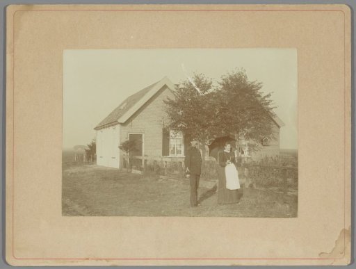 Constable and a woman with an umbrella in front of a residence