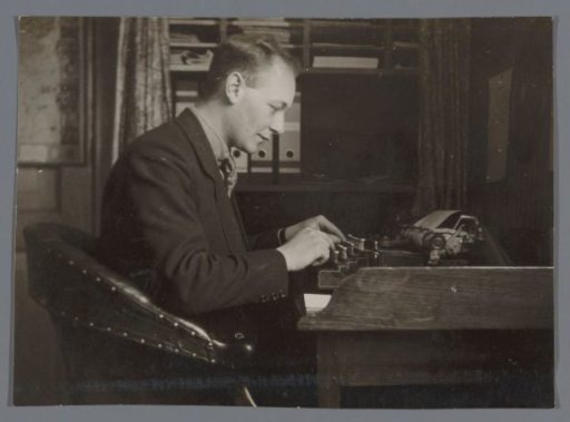 Portrait of an unknown man behind a typewriter