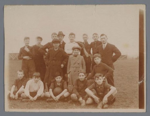 Group portrait of unknown boys on a grassy field