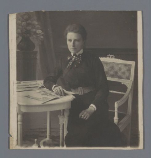 Portrait of an unknown woman at a table