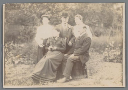 Portrait of two unknown men and three unknown women in a garden or park