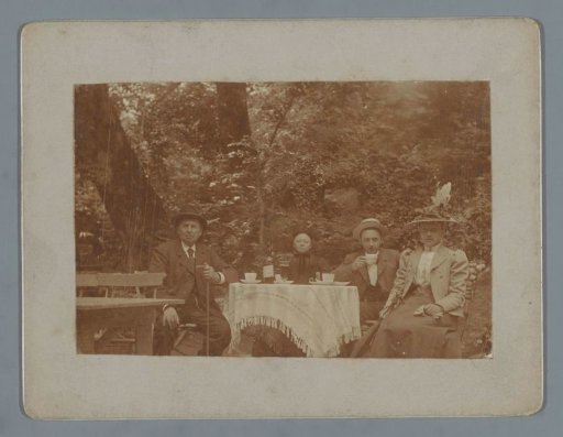 Group Portrait of an Unknown Family Around a Table in (Probably) a Park