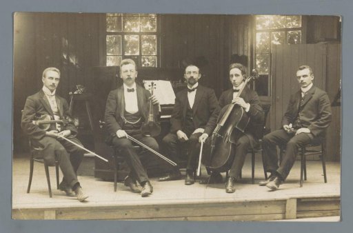 Group portrait of a musical ensemble on a stage