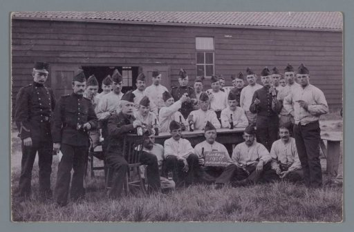 Group portrait of unknown men in uniform in front of (presumably) a barrack