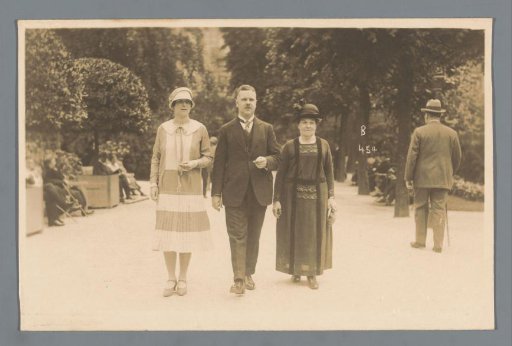 Portrait of an unknown man and two women in a park