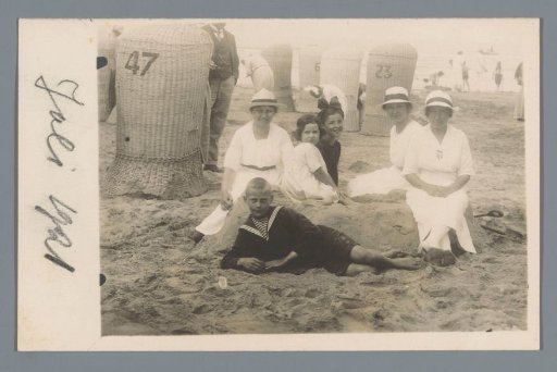 Portrait of three women with children on a beach