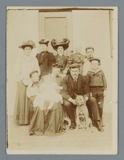 Group Portrait of an Unknown Family with a Dog Before a House