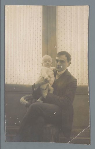 Portrait of an unknown man holding a child
