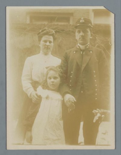 Portrait of a married couple with a child in a garden
