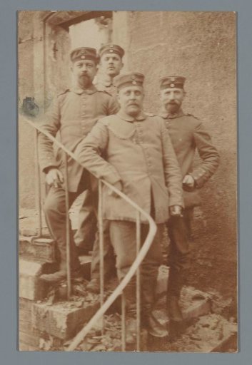 Portrait of Four Unknown Men in Uniform on a Staircase