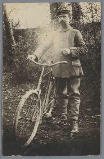 Portrait of an Unknown Man in Uniform Holding a Bicycle