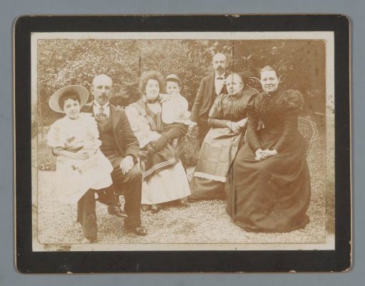 Group portrait of the Hoogendijk family, Johanna and Han van der Kop, in a garden in Schoonhoven