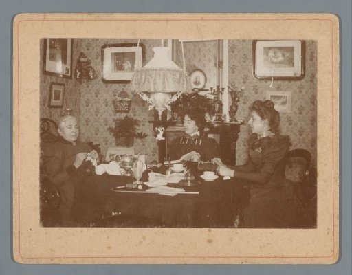 Portrait of Wilhelmina Gerarda Hoogendijk, her mother, and (presumably) her sister at a table in an interior