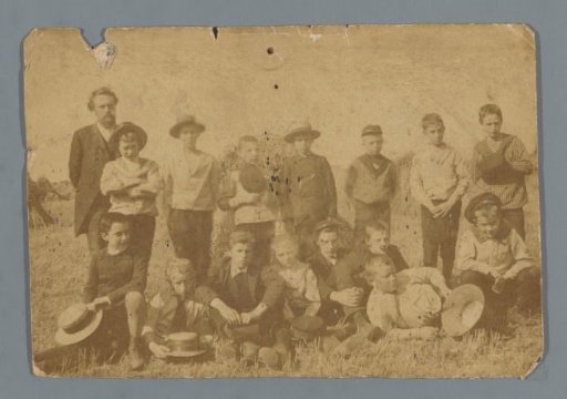 Group portrait of (presumably) a class of a boys' school with a teacher