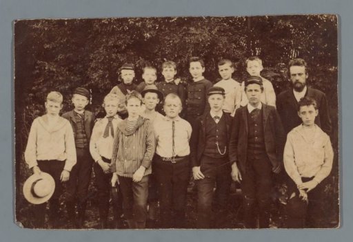 Group portrait of (presumably) a class of a boys' school with a teacher